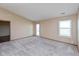 Large living room with plenty of natural light, and new carpet at 2680 Woodfield Blvd, Franklin, IN 46131
