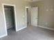 Bright bedroom with walk in closet, neutral walls and carpets. White trim around door and closet at 302 Sanders St, Indianapolis, IN 46225