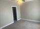 Bedroom with walk-in closet, carpeted floors, neutral paint, and ceiling fan at 302 Sanders St, Indianapolis, IN 46225