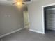 Bedroom with walk-in closet, carpeted floors, neutral paint, and ceiling fan at 302 Sanders St, Indianapolis, IN 46225