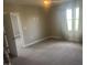 Neutral bedroom with large window and carpeted floors at 302 Sanders St, Indianapolis, IN 46225