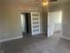 Neutral bedroom with ceiling fan, carpeted floors, and frosted sliding closet door at 302 Sanders St, Indianapolis, IN 46225