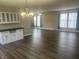 Open-concept living and dining area featuring hardwood floors and modern lighting fixtures at 302 Sanders St, Indianapolis, IN 46225