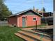Backyard with the deck leading to a matching garage with gray trim and door at 302 Sanders St, Indianapolis, IN 46225