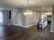Open-concept living and kitchen area featuring hardwood floors, stainless appliances, and a kitchen island at 302 Sanders St, Indianapolis, IN 46225