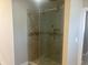 Modern shower with sliding glass door and tiled walls at 302 Sanders St, Indianapolis, IN 46225