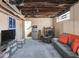 Finished basement with stairs, a mini-fridge, sofa, and a television at 3128 E Fall Creek Pkwy N Dr, Indianapolis, IN 46205