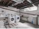 Basement laundry room with white washer and dryer, open ductwork and a small window at 3128 E Fall Creek Pkwy N Dr, Indianapolis, IN 46205