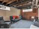 Finished basement area with a black futon, exercise equipment, and a small TV area at 3128 E Fall Creek Pkwy N Dr, Indianapolis, IN 46205