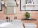 Classic pink-tiled bathroom featuring a marble countertop and decor shelves at 3128 E Fall Creek Pkwy N Dr, Indianapolis, IN 46205
