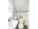 Bathroom features classic white tile, vintage fixtures, and accent trim detail at 3128 E Fall Creek Pkwy N Dr, Indianapolis, IN 46205