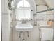 Charming bathroom with vintage fixtures, unique tile and an archway window at 3128 E Fall Creek Pkwy N Dr, Indianapolis, IN 46205