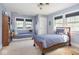 Light blue bedroom with a small twin bed and a built-in daybed next to a large window at 3128 E Fall Creek Pkwy N Dr, Indianapolis, IN 46205