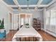 Elegant dining room featuring a coffered ceiling, chandelier, and large table, perfect for entertaining guests at 3128 E Fall Creek Pkwy N Dr, Indianapolis, IN 46205