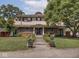 Inviting two-story home with manicured lawn and attractive landscaping, providing charming curb appeal at 3128 E Fall Creek Pkwy N Dr, Indianapolis, IN 46205