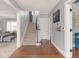Light-filled foyer showcasing a carpeted staircase and hardwood floors that add warmth and character at 3128 E Fall Creek Pkwy N Dr, Indianapolis, IN 46205