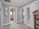 Hallway with multiple doors, carpeted floors and neutral paint at 3128 E Fall Creek Pkwy N Dr, Indianapolis, IN 46205