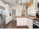 Bright kitchen with white cabinetry, stainless steel appliances, and a bar counter at 3128 E Fall Creek Pkwy N Dr, Indianapolis, IN 46205