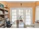 Office space with french doors, built-in bookshelf, and natural light at 3128 E Fall Creek Pkwy N Dr, Indianapolis, IN 46205