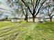 View of the backyard showing the detached garage, shed, and grass at 3136 Foltz St, Indianapolis, IN 46221