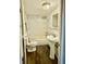 Bathroom features a toilet, sink, and a bathtub with a shower, and wood floors at 3136 Foltz St, Indianapolis, IN 46221