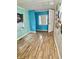 Empty bedroom featuring wood floors, blue walls, and natural light from window at 3136 Foltz St, Indianapolis, IN 46221