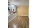 Empty bedroom with wood floors and a colorful alphabet mural on the wall at 3136 Foltz St, Indianapolis, IN 46221