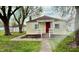 Home featuring a covered porch, red front door, and a walkway leading to the entrance at 3136 Foltz St, Indianapolis, IN 46221