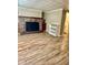 Living room with wood floors, fireplace, and shelving, leading to bathroom at 3136 Foltz St, Indianapolis, IN 46221