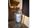 Mechanical room with hot water heater, water softener, and dark wood floor at 3136 Foltz St, Indianapolis, IN 46221