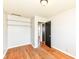 Empty bedroom with hardwood floors, closet shelving, and neutral paint at 319 E Ohio St, Fortville, IN 46040