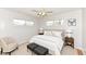 Cozy bedroom featuring a plush bed, accent chair, and soft neutral tones at 319 E Ohio St, Fortville, IN 46040