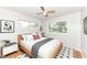 Bright bedroom with a modern bed frame, two windows, and hardwood floors at 319 E Ohio St, Fortville, IN 46040