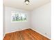 Well-lit bedroom with hardwood floors and a large window overlooking the neighborhood at 319 E Ohio St, Fortville, IN 46040