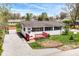 Charming single-story home with a red porch, gravel driveway, and well-maintained landscaping at 319 E Ohio St, Fortville, IN 46040