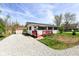 Charming single-story home with a red porch, gravel driveway, and well-maintained landscaping at 319 E Ohio St, Fortville, IN 46040