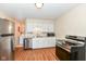 Kitchen featuring stainless steel appliances, ample counter space, and vinyl wood-look flooring at 319 E Ohio St, Fortville, IN 46040