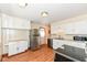 Bright kitchen featuring ample cabinets, stainless steel appliances, and wood-look flooring at 319 E Ohio St, Fortville, IN 46040