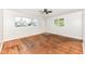 Bright living room with hardwood floors, ceiling fan, and natural light at 319 E Ohio St, Fortville, IN 46040