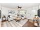 Staged living room with a ceiling fan, comfortable seating, and ample natural light at 319 E Ohio St, Fortville, IN 46040