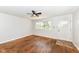 Bright living room with hardwood floors, ceiling fan, and natural light at 319 E Ohio St, Fortville, IN 46040