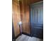 A look at the entryway that features wood paneling and a door at 325 Harlan St, Indianapolis, IN 46201