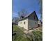 Outside view of the house featuring siding, a brown roof, and green grass at 325 Harlan St, Indianapolis, IN 46201