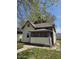 Charming home with siding and porch needing some TLC, surrounded by a lush green yard at 325 Harlan St, Indianapolis, IN 46201