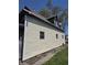 Low angle exterior view that features siding, windows, and a brown roof at 325 Harlan St, Indianapolis, IN 46201