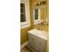 Bathroom vanity with gray cabinets, a modern sink, mirror, and window at 3601 N Kenwood Ave, Indianapolis, IN 46208