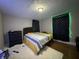 The bedroom features a decorative rug, black dresser, and curtains with LED lights at 3601 N Kenwood Ave, Indianapolis, IN 46208