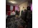 Bedroom with dark furniture, red curtains and a decorative rug on vinyl flooring at 3601 N Kenwood Ave, Indianapolis, IN 46208