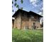 Charming stone-clad home featuring a well-maintained lawn under a sunny sky at 3601 N Kenwood Ave, Indianapolis, IN 46208