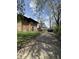Exterior view of the property with a long driveway and additional parking at 3601 N Kenwood Ave, Indianapolis, IN 46208